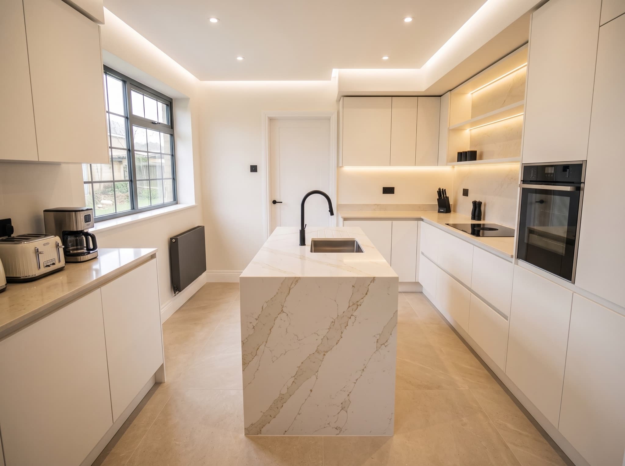 AI kitchen island design comparison: an empty floor center gains a quartz waterfall island with a prep sink — after, AI kitchen design result